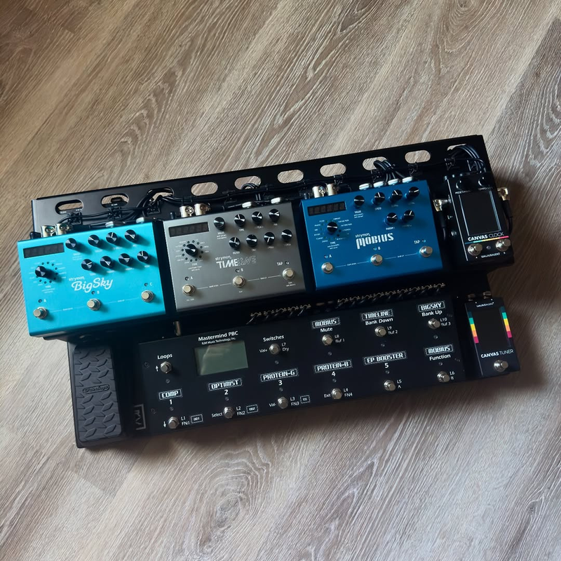 Vince holding a custom pedalboard build